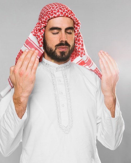 Portrait of muslim man praying with eyes closed