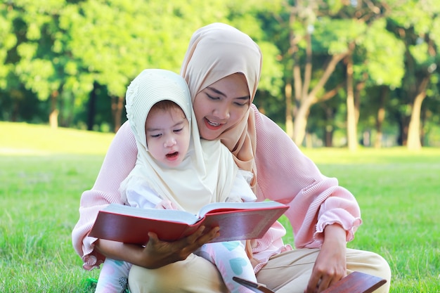 Portrait of a Muslim woman reading to her daughter