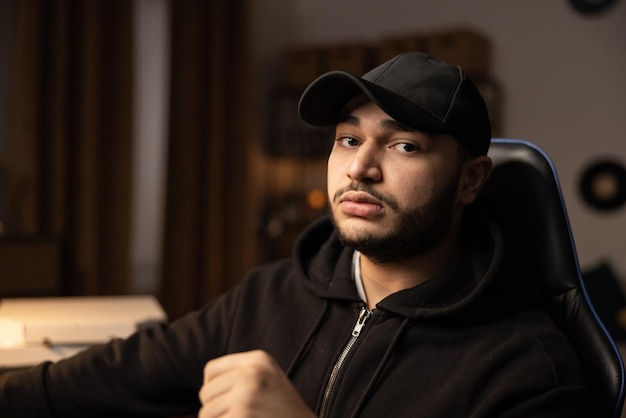 Portrait of a mysterious man wearing a baseball cap and a black sweatshirt