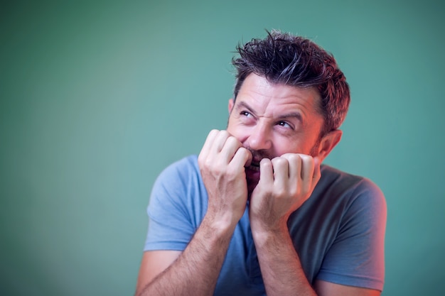 Portrait of nervous man biting his nails