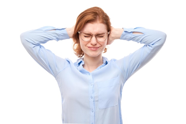 Photo portrait of nervous young woman covering ears with hands isolated on white background stress emotional burnout selfdoubt concept