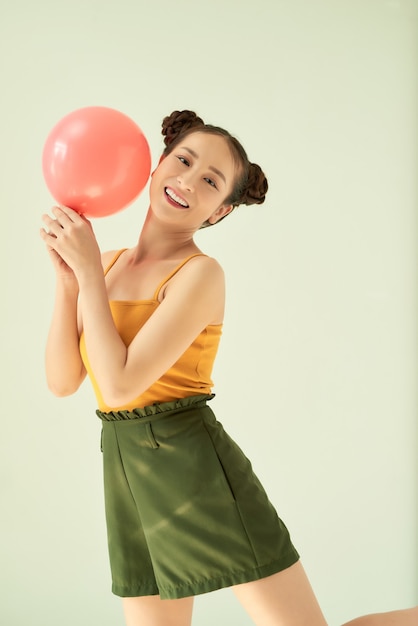 Portrait of nice cute lovable adorable attractive lovely cheerful cheery positive girl holding air baloon