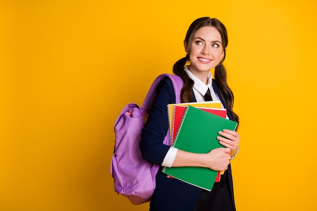 portrait of nice pretty schoolgirl nerd holding in hand course copybook