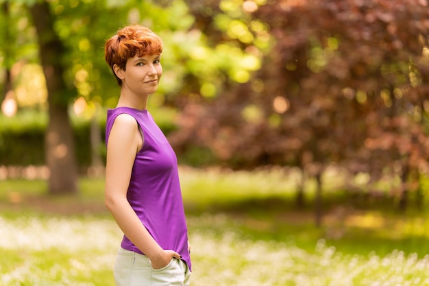 Portrait of nonbinary person turning to smile to camera