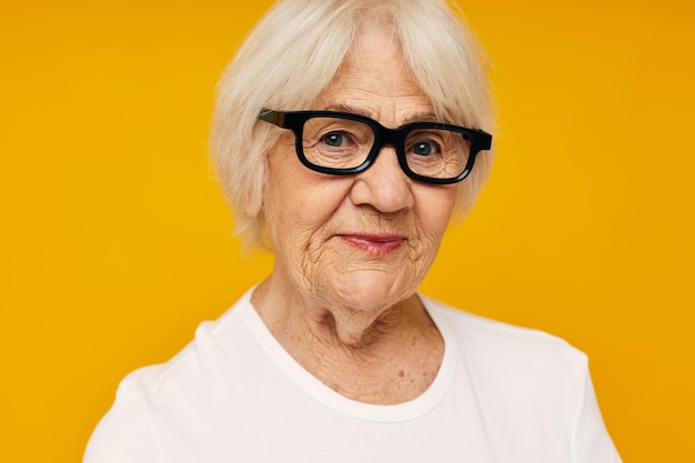 Portrait of an old friendly woman health lifestyle eyeglasses isolated background