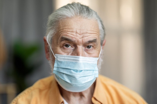 Portrait of an old man wearing a medical mask