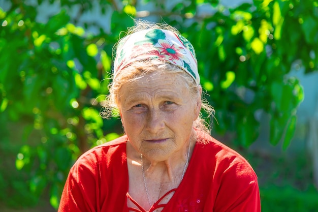 Portrait of an old woman in the garden Selective focus