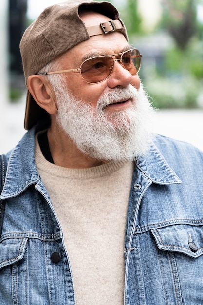 Portrait of older man posing while outdoors in the city