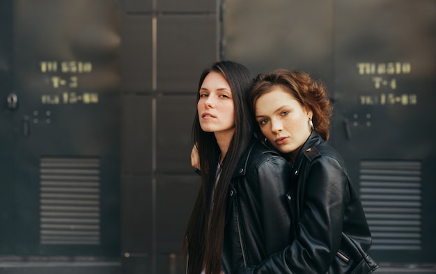 Portrait of a pair of girls in leather jackets posing