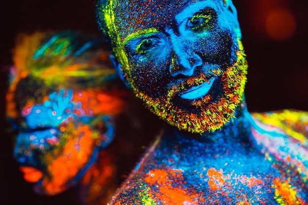 Portrait of a pair of lovers painted in fluorescent powder.