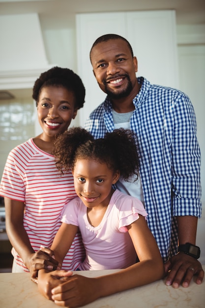 Portrait of parents and daughter in kitchen