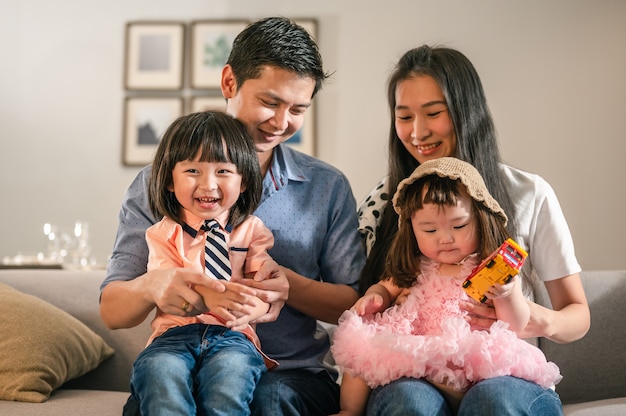 Portrait of parents happy full family with children have fun sitting on sofa in living room leisure