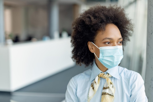 Portrait of pensive black businesswoman with protective face mask