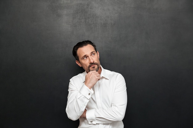 Portrait of a pensive mature man dressed in shirt