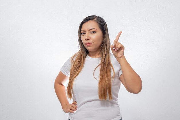 Portrait of person raising hand Portrait of Mexican woman isolated on white background waiting to be selected