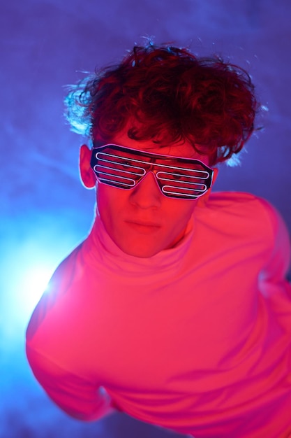 Photo portrait of person wearing futuristic led glasses looking up