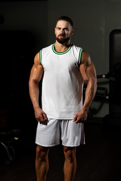 Portrait Of Personal Trainer In Sports Outfit In Fitness Center Gym Standing Strong