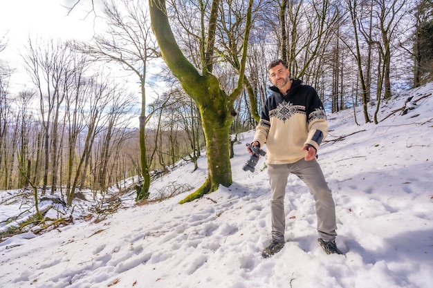 Portrait of a photographer man in snow enjoying winter photography