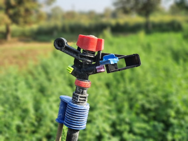 Photo portrait photography of water sprinkler in farm