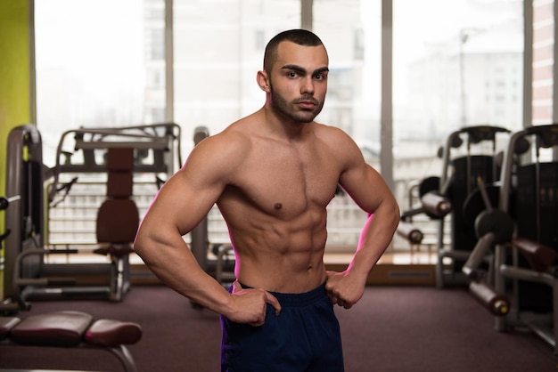 Portrait Of A Physically Fit Man Showing His Well Trained Body In Gym