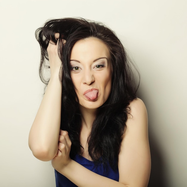 Portrait picture of teenage girl sticking out her tongue