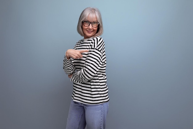 Portrait of a pleasant wellgroomed slender middleaged grandmother with gray hair in a youth look on