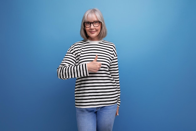 Portrait of a pleasant woman s in a fashionable image on a bright studio background