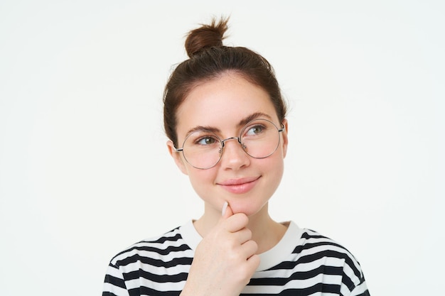 Portrait of pleased and thoughtful face smiling satisifed analizing smth thinking standing over