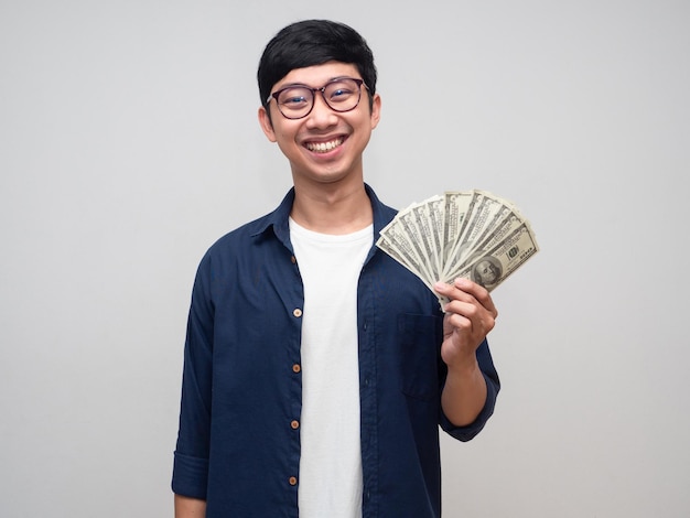 Portrait positive asian man happy smile holding a lot of money isolated