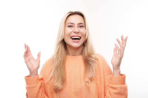 Portrait positive blonde girl emotionally rejoices and feels happy satisfied isolated on white background advertising banner