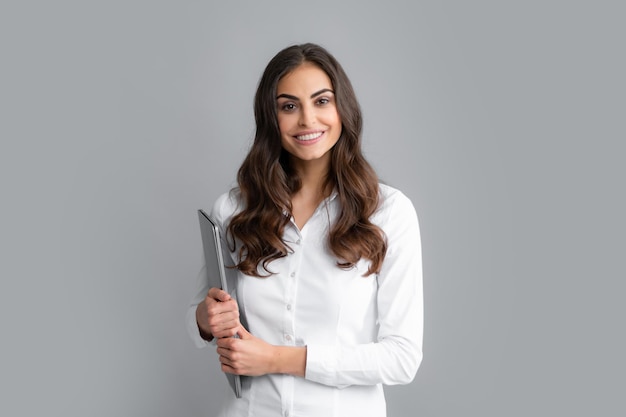 Portrait of positive cheerful ceo expert business woman work at laptop isolated over gray background Secretary with laptop studio portrait