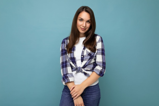 Portrait of positive cheerful fashionable woman in hipster outfit isolated on blue background with