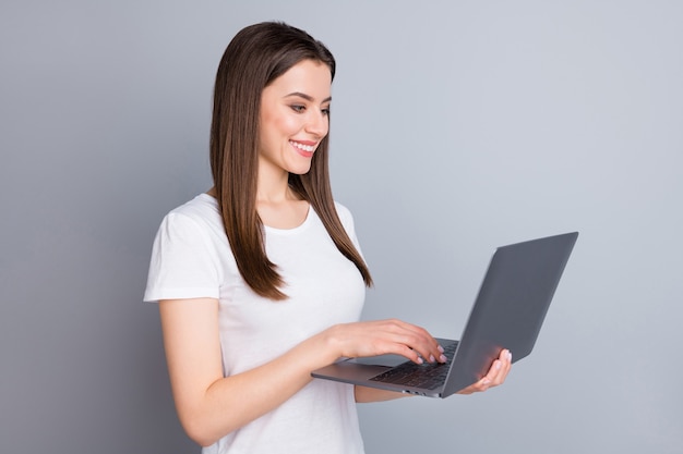 Portrait of positive cheerful girl marketer hold laptop work