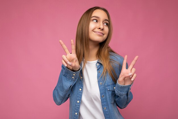 Portrait of positive happy young beautiful dark blonde woman with sincere emotions wearing blue