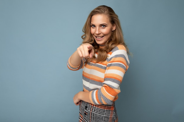 Portrait of positive young beautiful blonde curly woman with sincere emotions