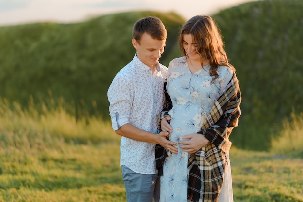 Portrait of a pregnant woman with her boyfriend. Happy couple expecting a baby, young family concept