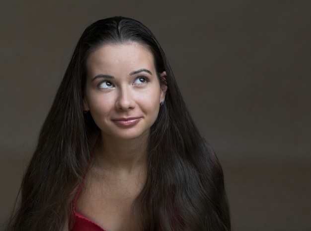 Portrait of a pretty brunette girl with beautiful lips and hair.