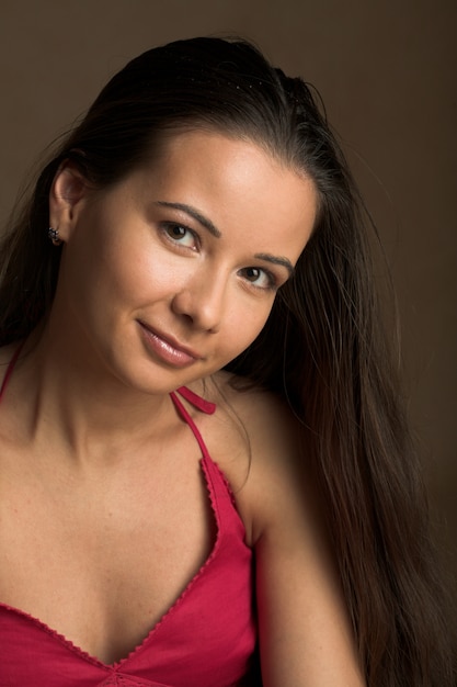 Portrait of a pretty brunette girl with beautiful lips and hair.