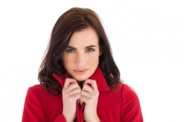 Portrait of a pretty brunette in red coat