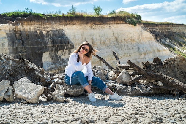 Portrait of pretty girl relax in sand of desert. perfect vacation on suumer time. lifestyle