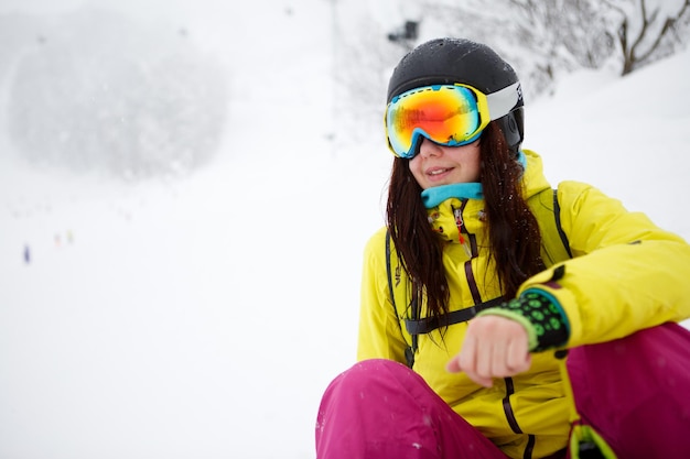 Portrait of pretty girlsitting on snow