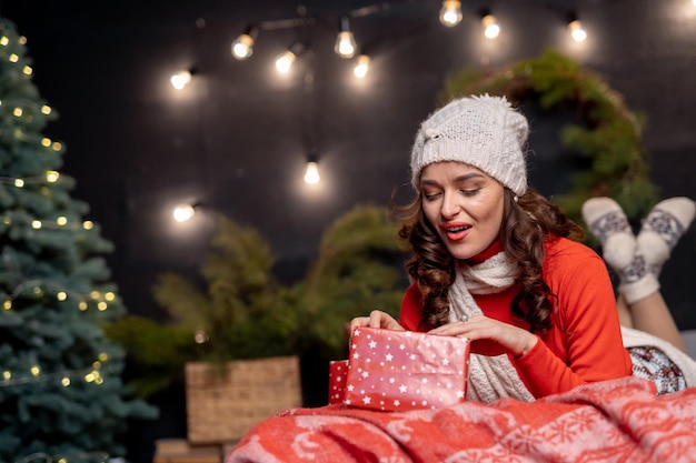 Portrait of pretty woman in christmas interior Young beautiful lady with new year decoration