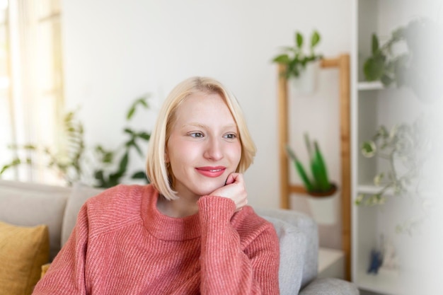 Portrait of pretty woman with blond dark hair Natural smile. smiling beautiful and looking thru the window