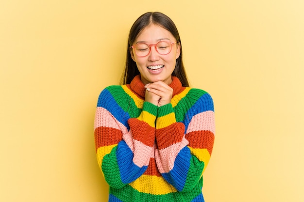 Portrait of pretty young Asian woman isolated on yellow background