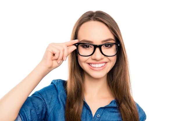 Portrait of pretty young happy secretary touching glasses