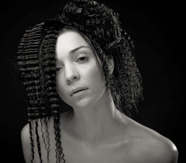 Portrait of pretty young woman with curly hair 