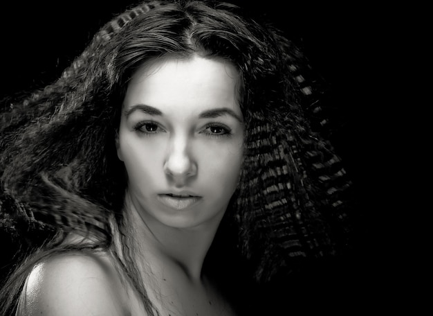 Portrait of pretty young woman with curly hair