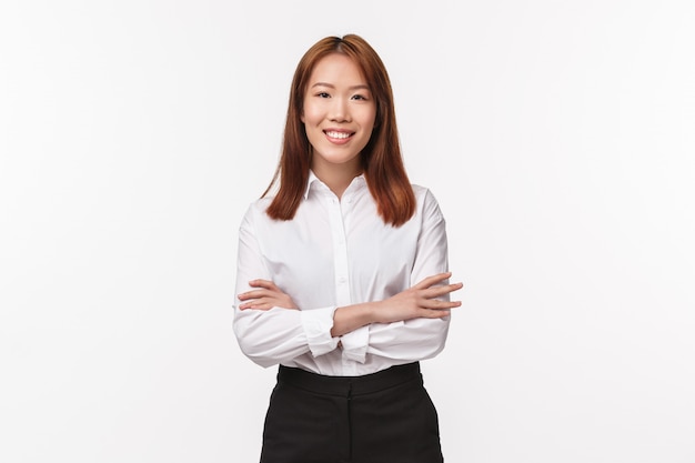 Portrait of professional smart and creative lady boss, female entrepreneur in white elegant shirt, cross hands over chest and smiling satisfied, run successful business, 