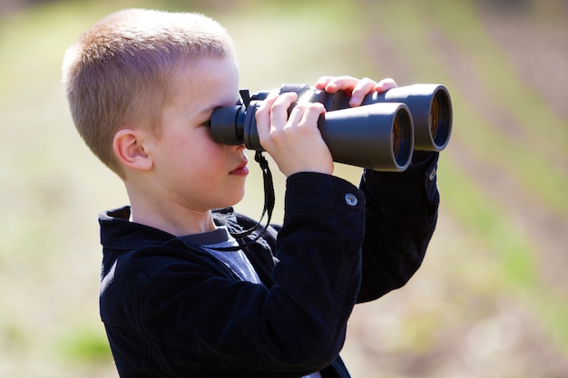 Portrait in profile of little handsome cute blond boy looking th