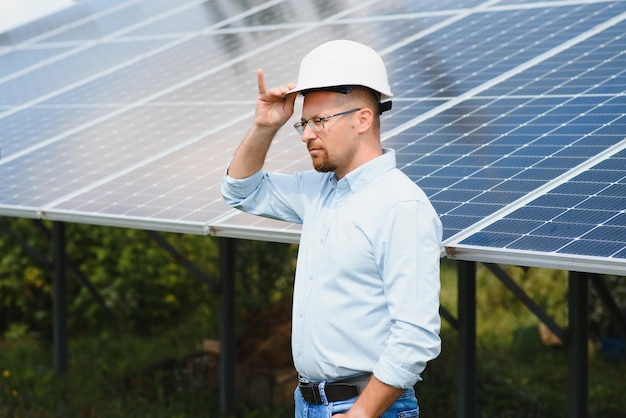 The portrait of a proud engineer smiles satisfied with his successful work Concept renewable energy technology electricity service green power